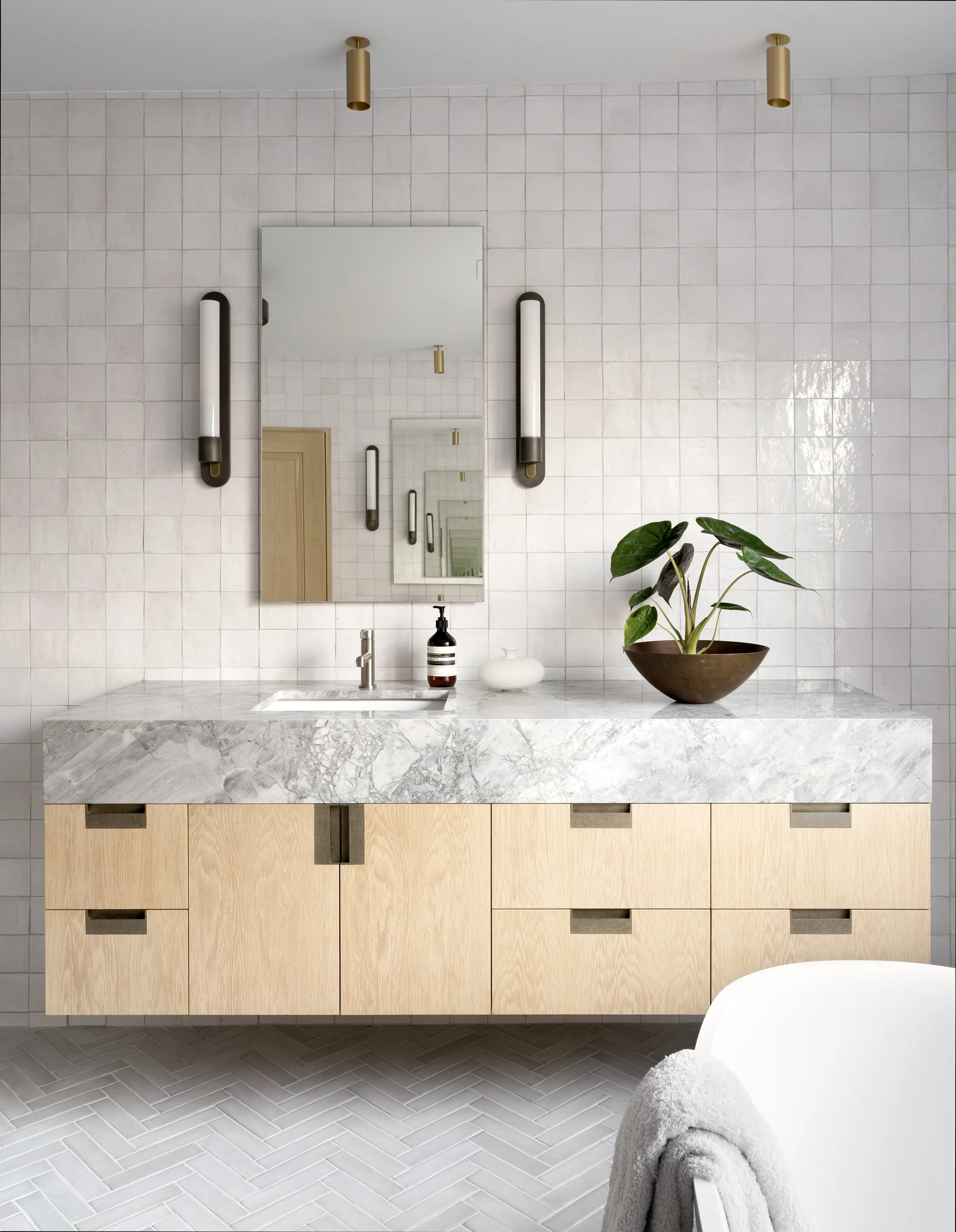 Primary bathroom with custom vanity, handmade zellige tile, and medicine cabinet at Boulevard Oaks by Cravotta Interiors. 