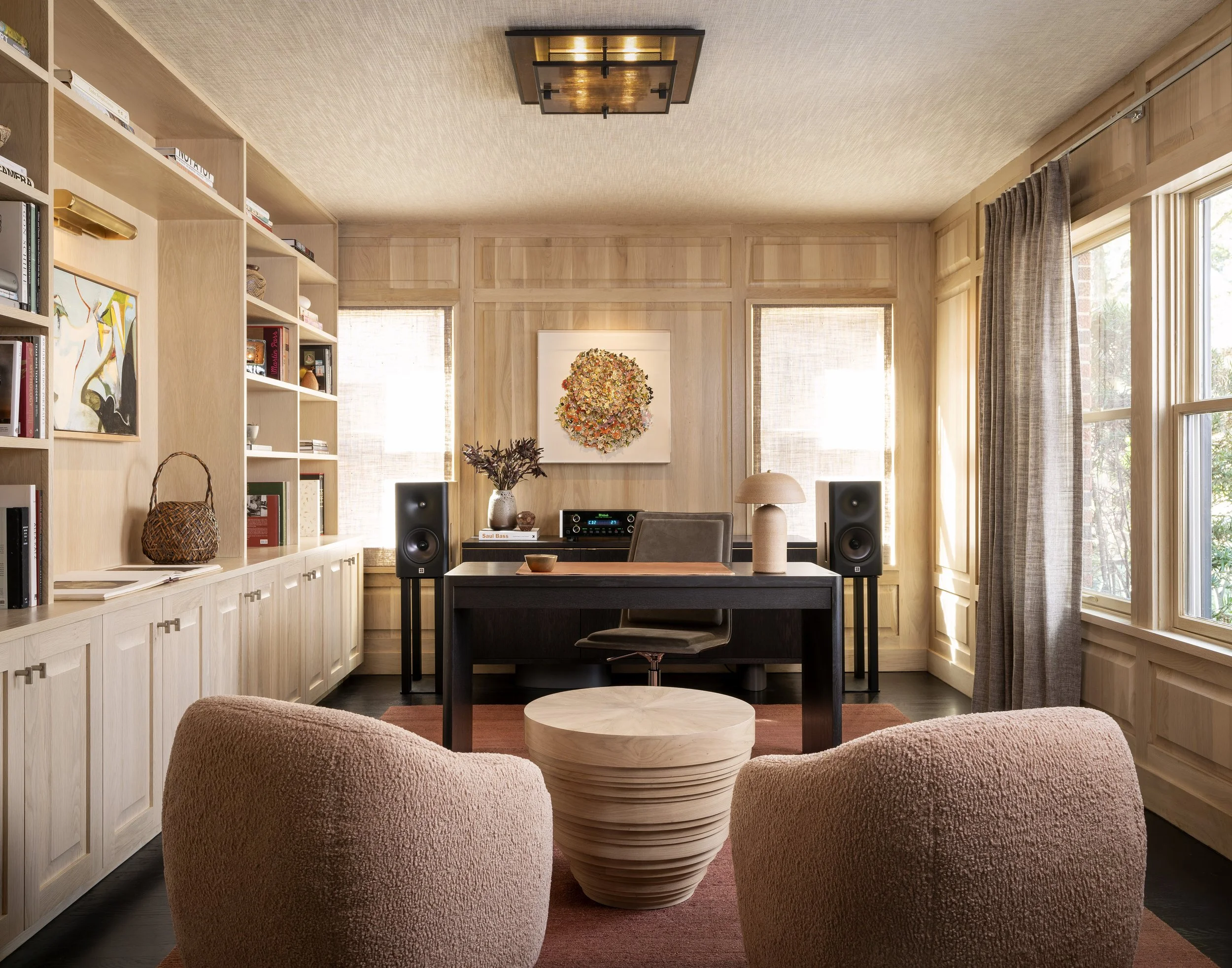  Oak-paneled library office with fabric ceiling and hi-fi stereo in warm tones at Boulevard Oaks by Cravotta Interiors. 