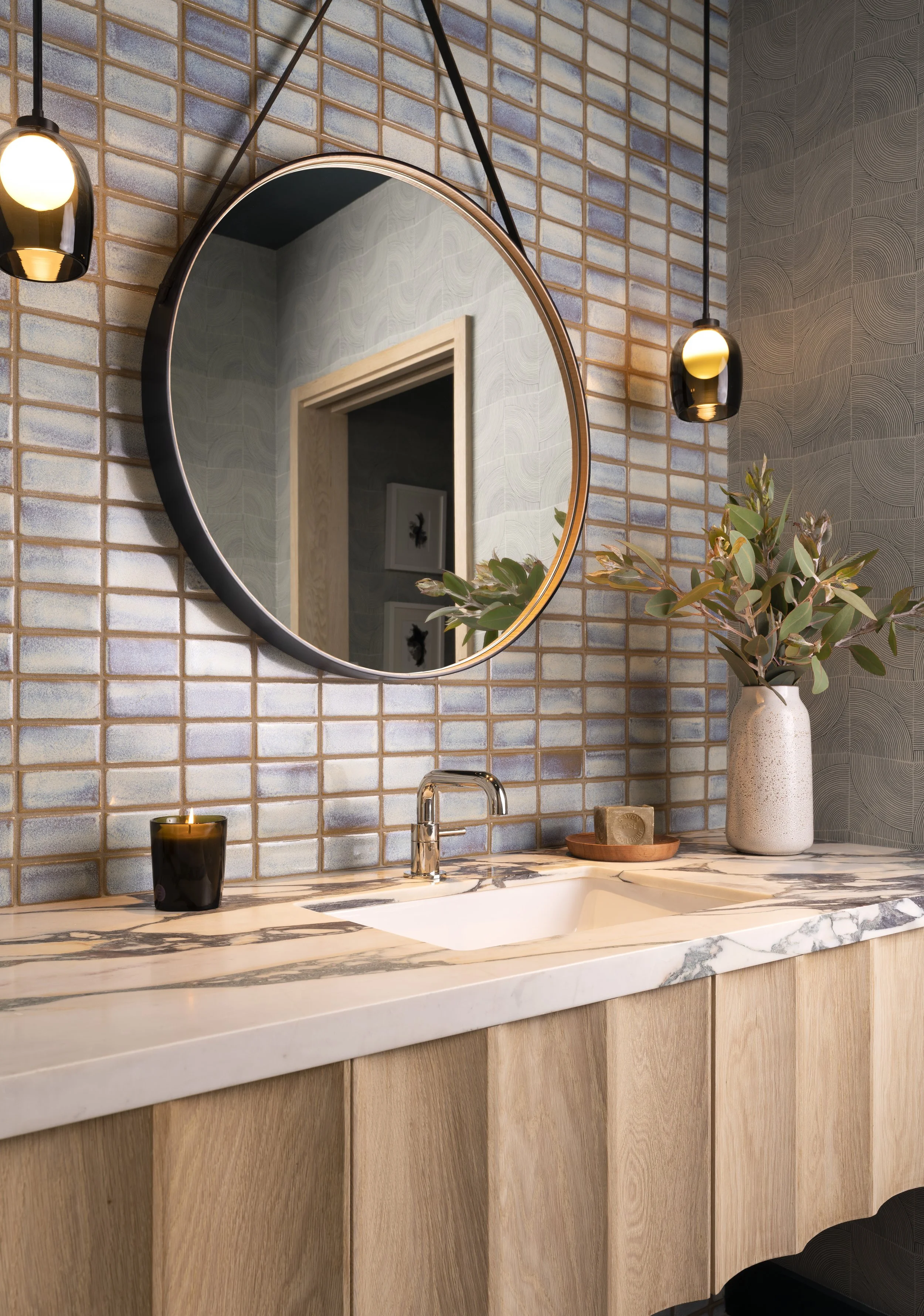  Powder room with handmade tile, custom vanity, BDDW mirror, and Allied Maker lights at Boulevard Oaks, designed by Mark Cravotta. 