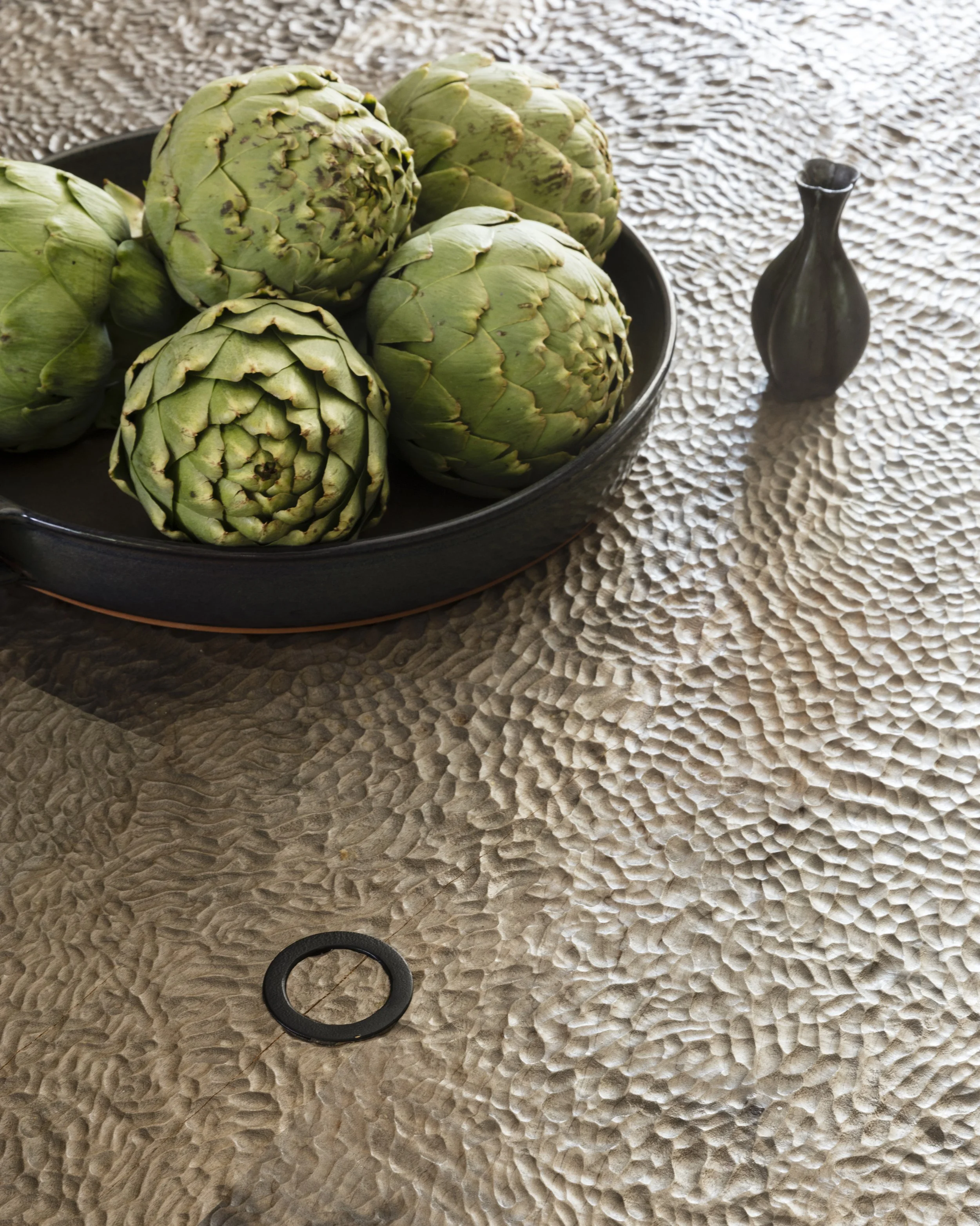  Hand-carved walnut table with bronze inserts at the Rabb Road dining room, designed by Mark Cravotta. 