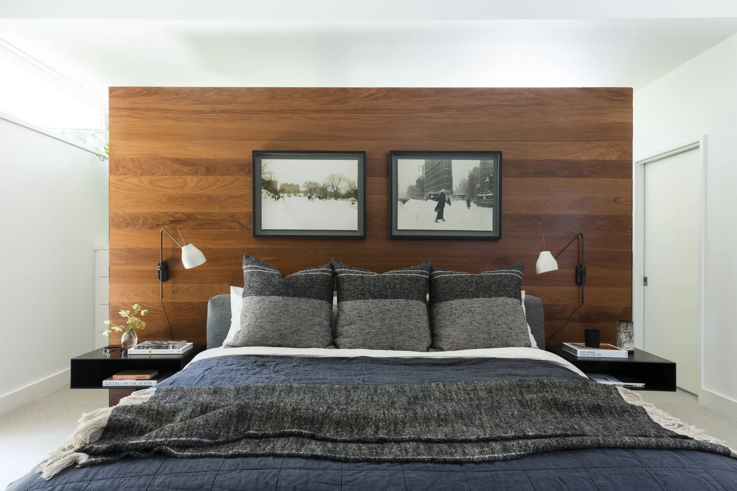  Bedroom with walnut wall paneling flooded with light at Rabb Road by Cravotta Interiors. 