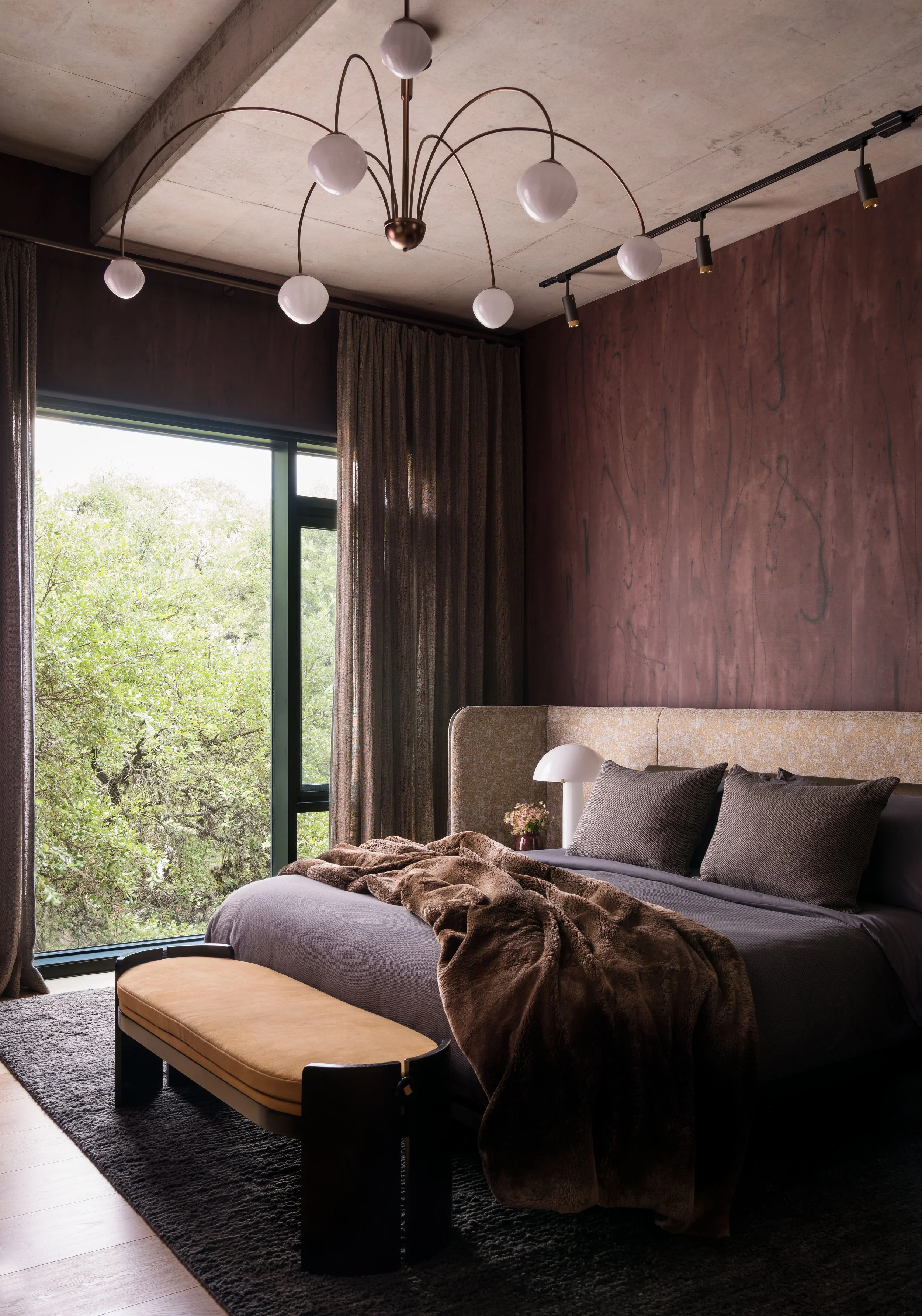  Primary bedroom with Porter Teleo wallpaper, Jiun Ho bed, and sculptural chandelier at St. Cecilia by Cravotta Interiors. 