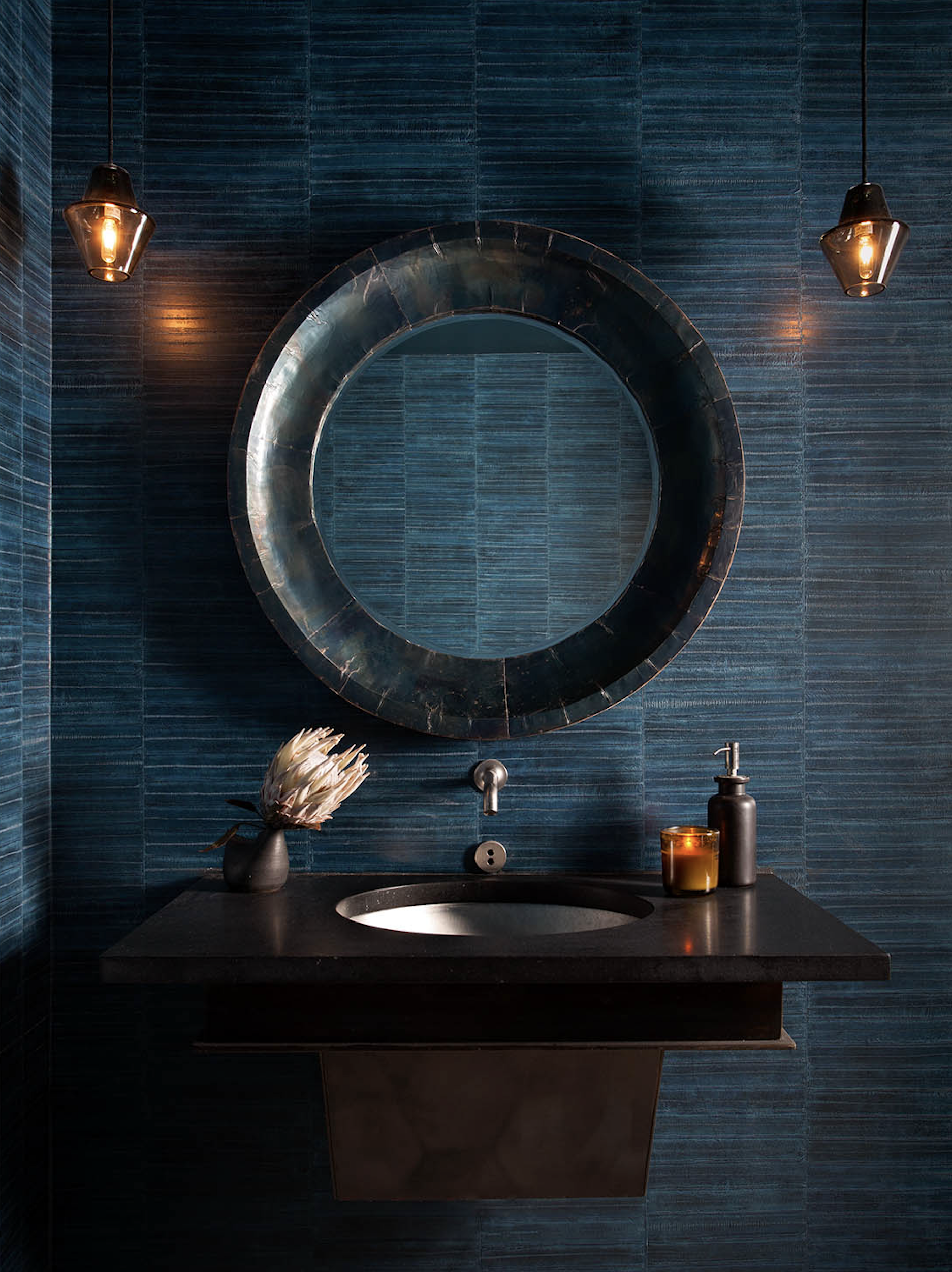 Juniper restaurant restroom with custom floating vanity, Studio Dunn blown glass pendants, and round mirror, designed by Cravotta Interiors