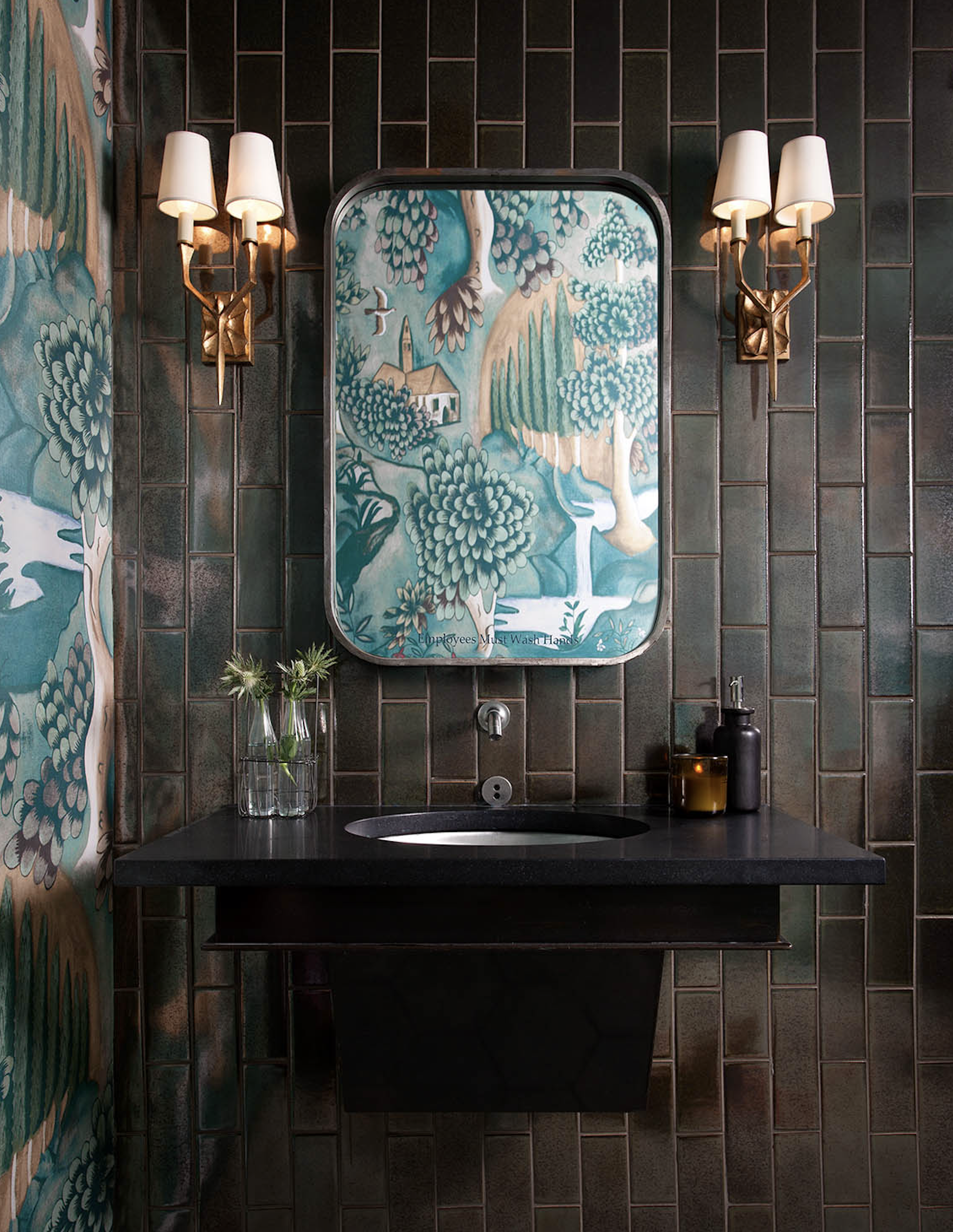 Juniper restaurant restroom with custom floating vanity, French brass sconces, and Ann Sacks metallic wall tile, designed by Cravotta Interiors